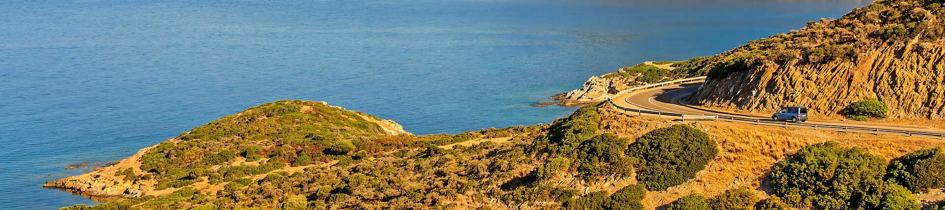 Sardinien Südküste: Türkisfarbenes Meer, weißer Sandstrand und strahlend blauer Himmel.