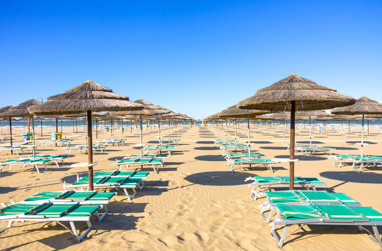 Liegen und Sonnenschirme an einem Strand in Rimini