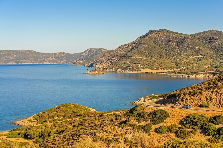 Auto steht an einer Küste auf Sardinien