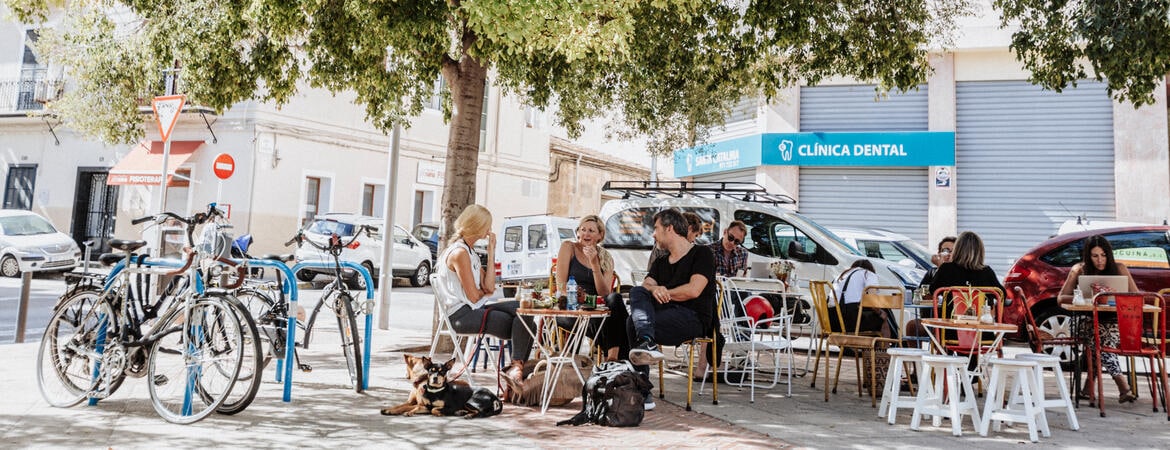 Menschen sitzen draußen an Tischen des Cafés Mama Carmens auf Mallorca